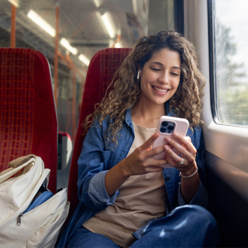 Woman on train looking at phone screen